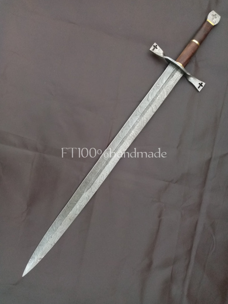 Handmade Damascus steel sword with rosewood and brass handle; leather sheath included.